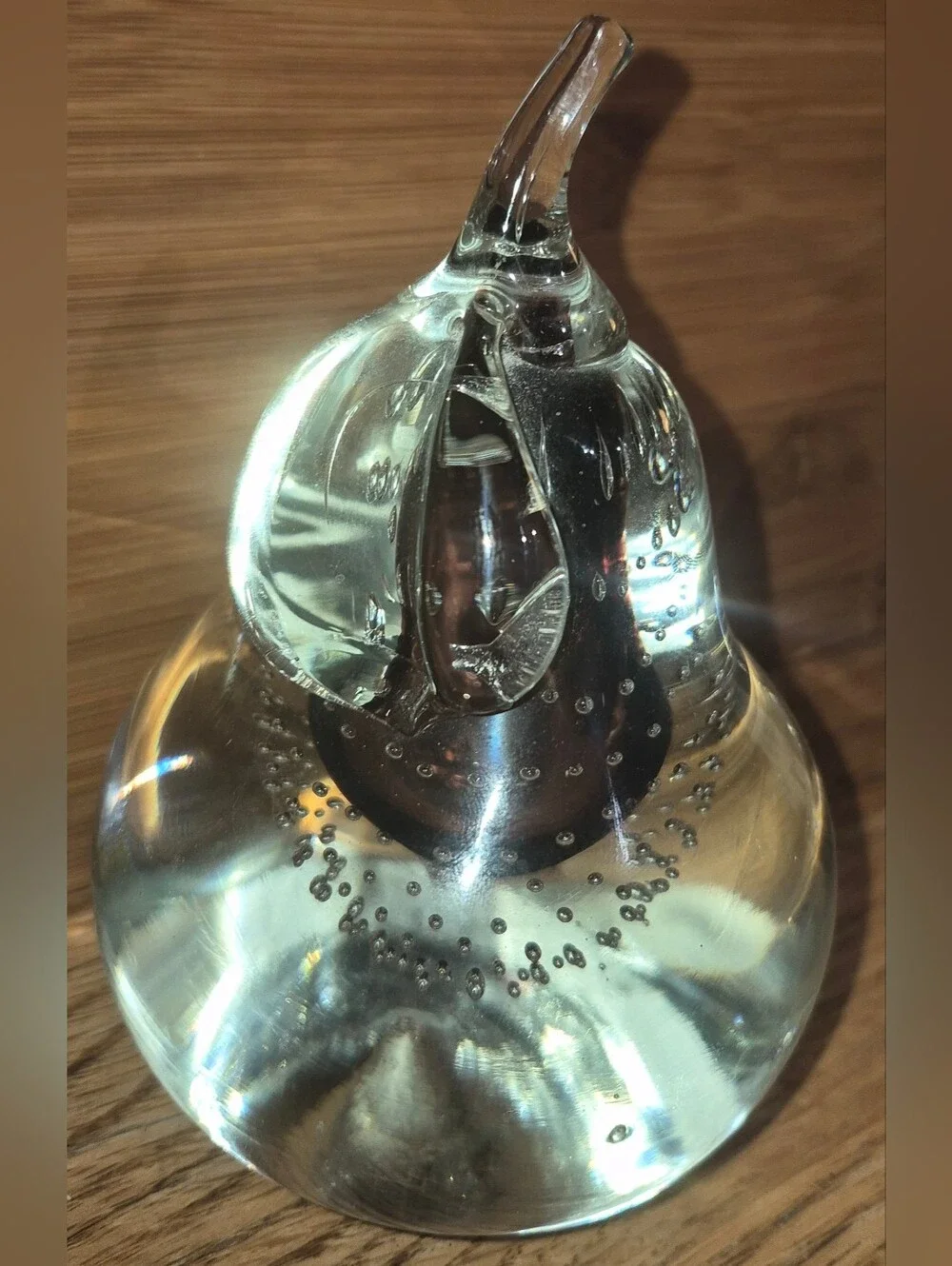 Vintage clear glass pear paperweight featuring controlled bubbles